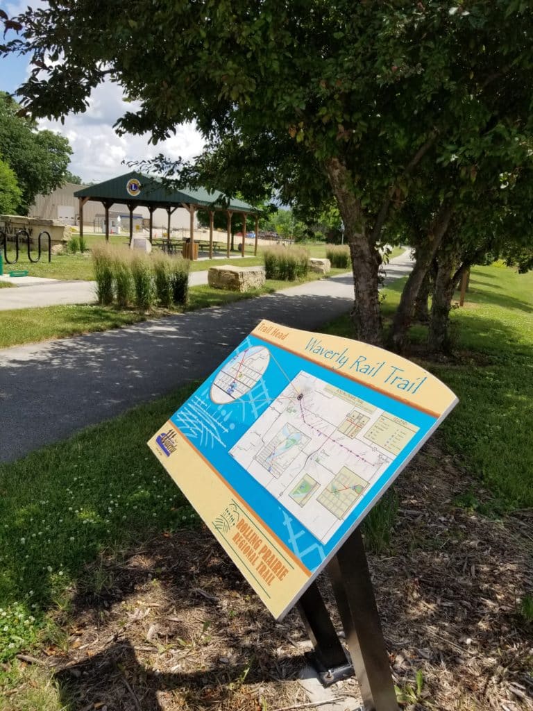 bike trail sign and a shelter in the background