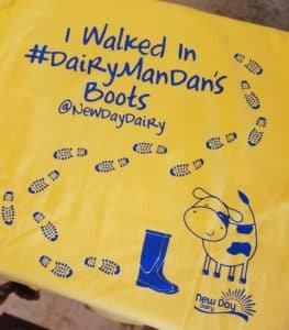 back of a yellow t-shirt that says "I walked in #DairymanDan's boots"