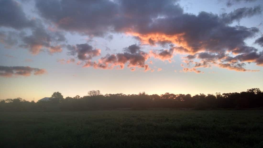 Sunrise over the barn on the prairie