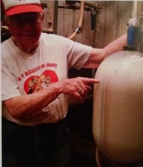 Dan's Grandpa Neil showing off how he used to measure the milk