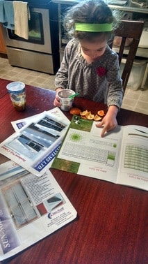 Kid looking at cow magazine