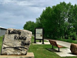 Rolling Prairie Bike Trail Sign at Trailhead with bench and kiosk with information