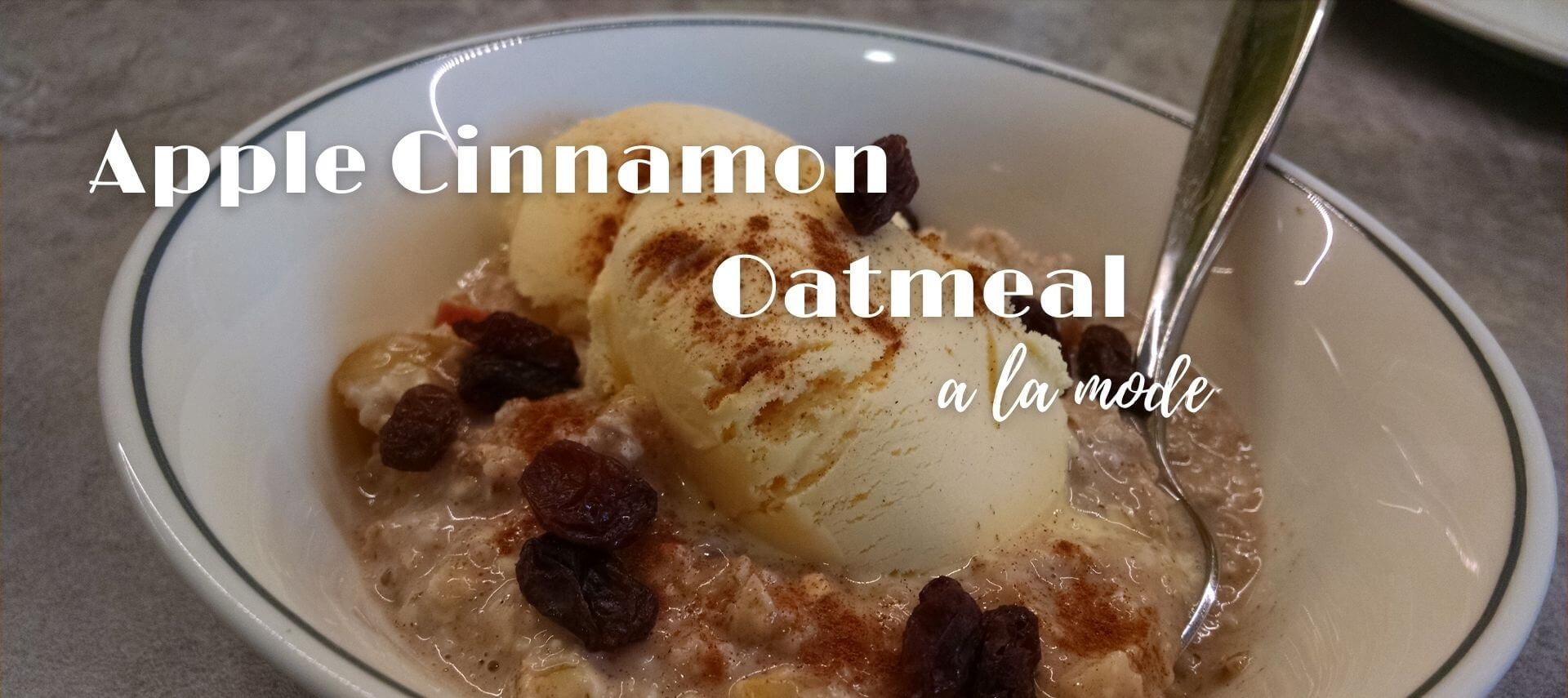 bowl of oatmeal with ice cream on top and spoon