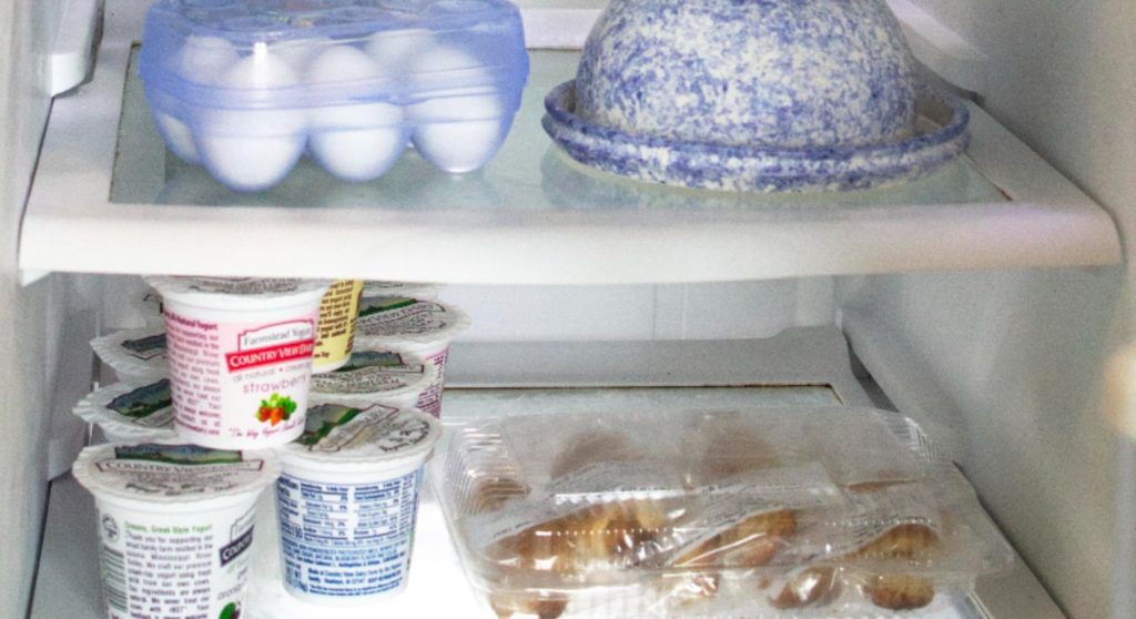 inside of refrigerator holding hard boiled eggs, yogurt containers and dutch letters