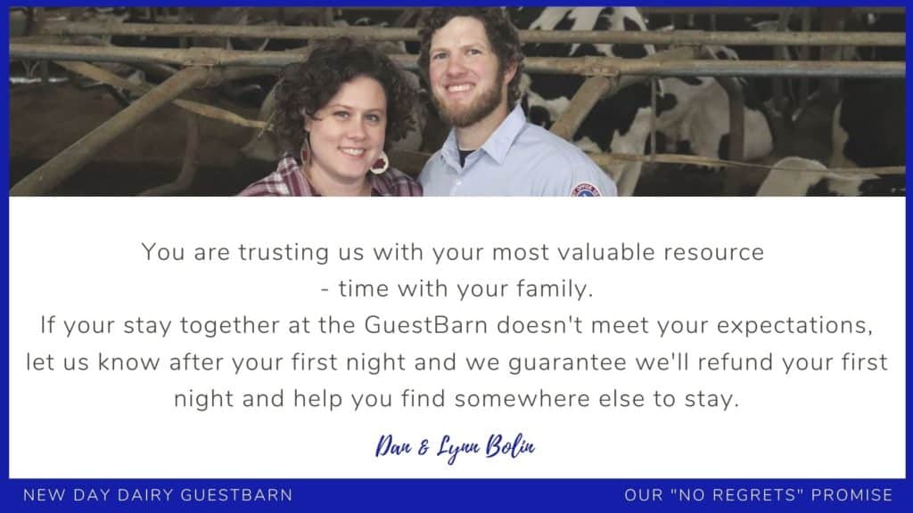 man and woman standing in a dairy barn