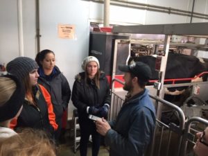 Group of People Touring Robot Room at Dairy Farm