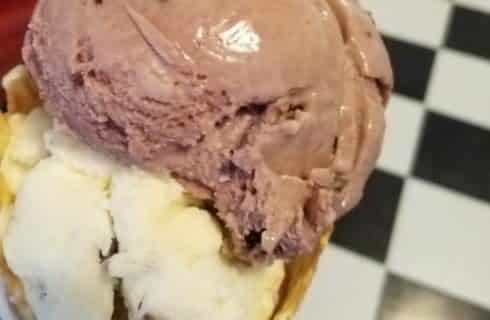 Close up view of ice cream cone with chocolate and vanilla ice cream scoops