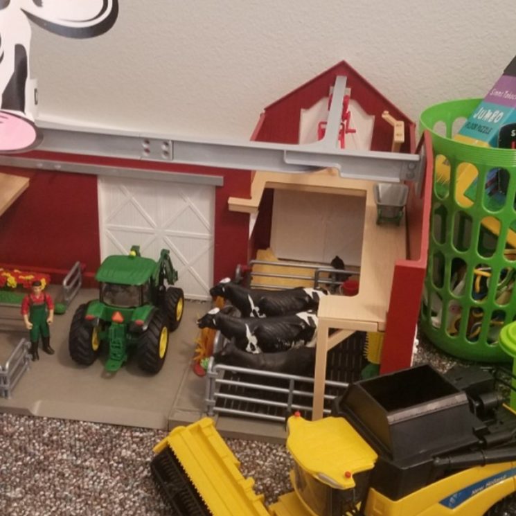 toy barn, tractors with coloring book, puzzle box, and paper cow hat