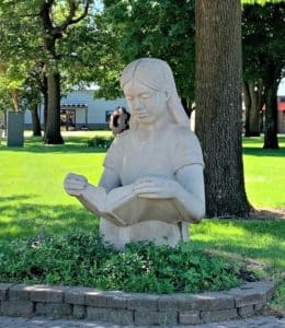 statue of a girl reading a book