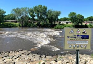 White Water Rapids at River with Sign